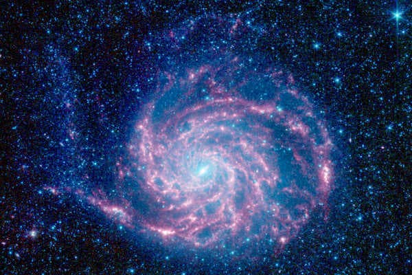 An infrared image of Messier 101, or the Pinwheel Galaxy, which is 170,000 light-years across and twice the diameter of the Milky Way, captured by the Spitzer Space Telescope in 2008.